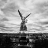 Der Friedensengel vor Münchens Stadtbild in schwarz-weiß. Fotografie von James Murray.